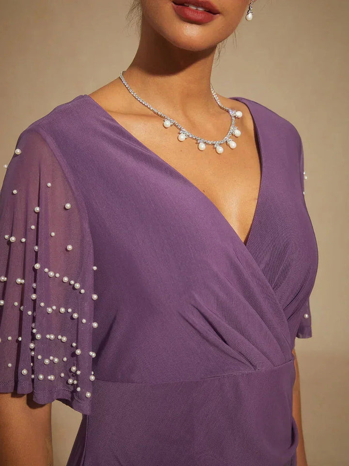 Elegante Formele Galajurk met Versierde Fladdermouwen